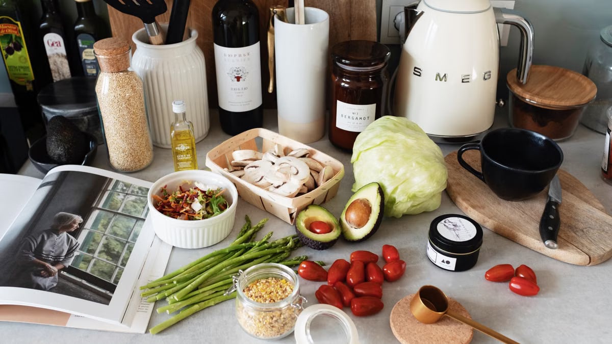 A variety of fresh ingredients and kitchen tools for preparing a healthy meal.