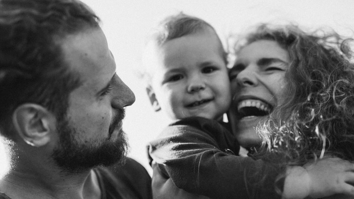 A happy family enjoying a heartfelt moment together in a black-and-white setting.